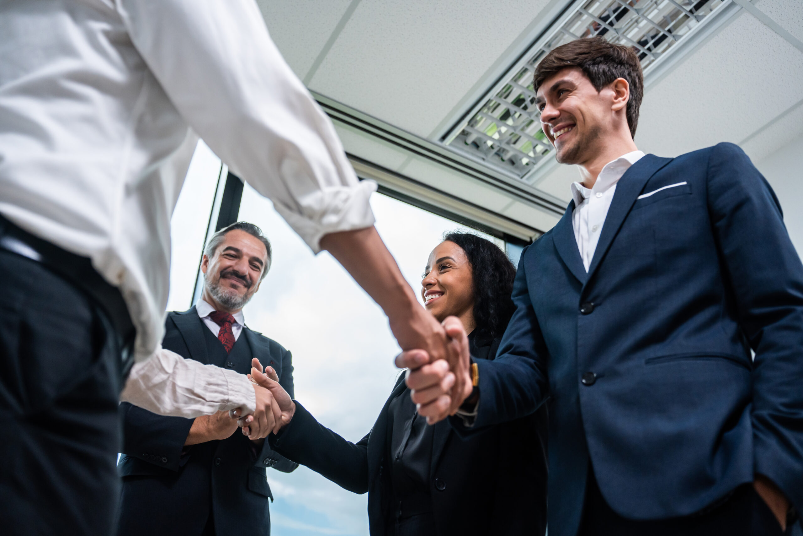 People in business attire shaking hands