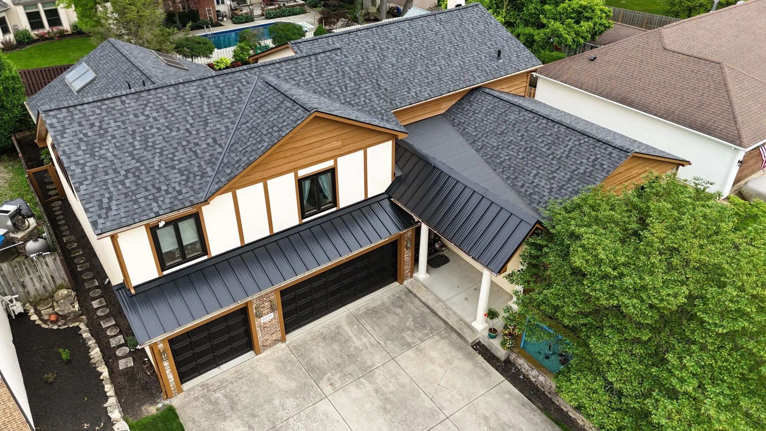 Newman Roofing residential project showcasing modern shingle and metal roofing.