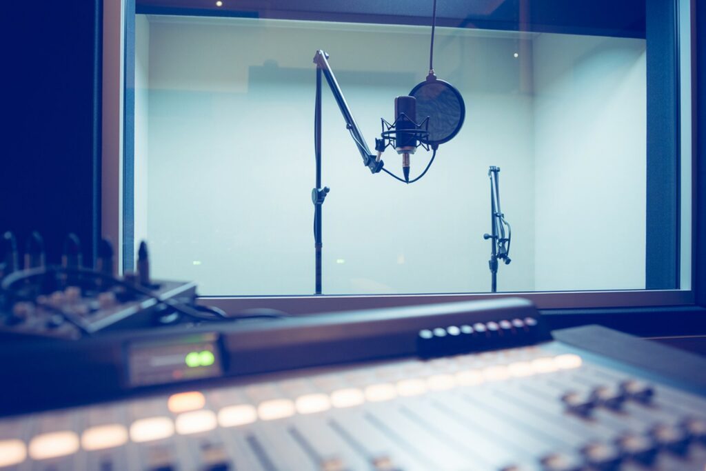 Recording booth microphone seen from a studio control room