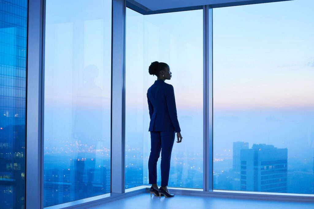 Marketing leader looking over the city skyline at dawn